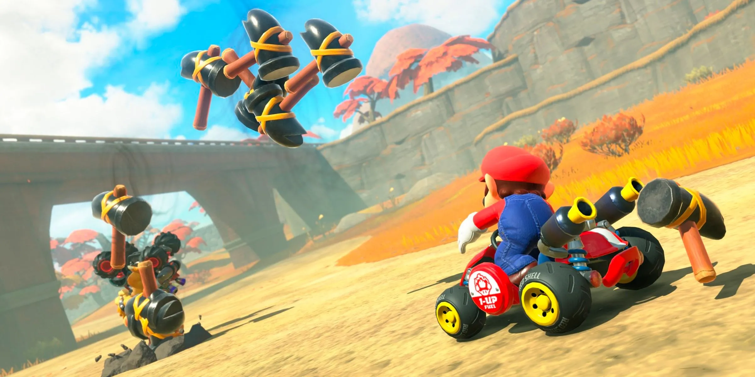 Mario sử dụng vật phẩm Hammer tấn công Bowser trong Mario Kart World.