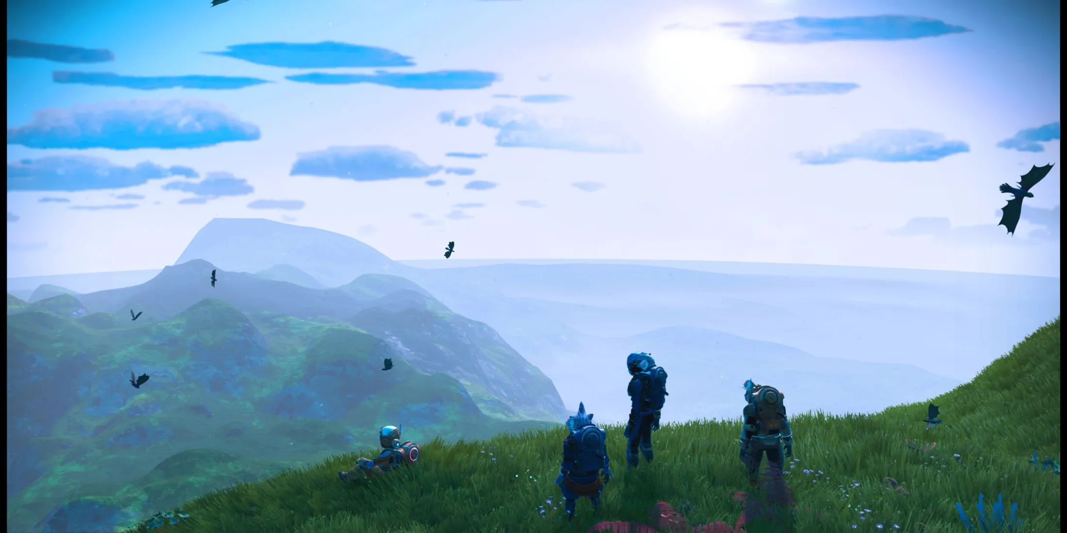 Nhóm người chơi khám phá địa hình núi non hiểm trở trong No Man's Sky, minh họa khả năng multiplayer và môi trường procedural rộng lớn của game
